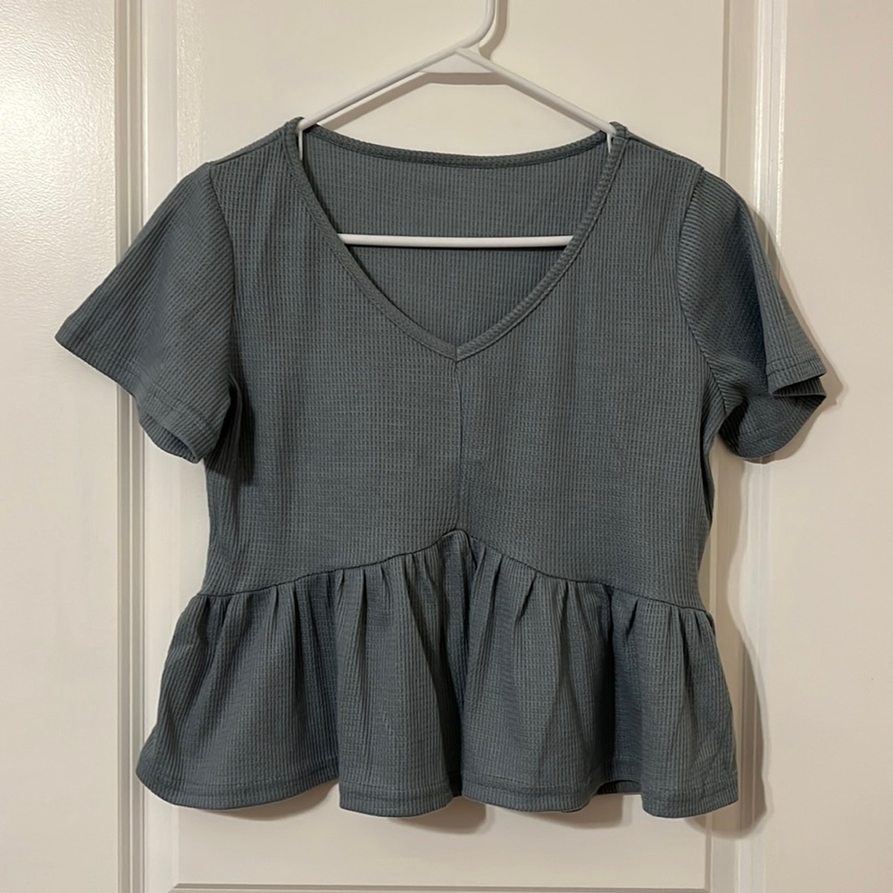 Adorable blue top with ruffle bottom.